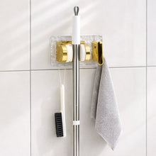 Space saving broom and mop hanger